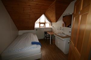 A single room with shared bathroom