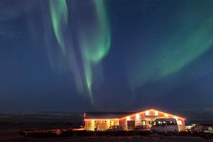 Vogafjós by Lake Mývatn bathed in northern ligts