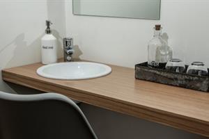 Room with shared bathroom with hand basin