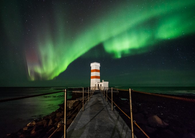 Aurora Borealis dancing over a lighthouse in Iceland Aurora Borealis dancing over a lighthouse in Iceland