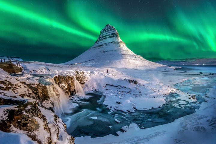 Northern Lights dancing over Kirkjufell Mountain Northern Lights dancing over Kirkjufell Mountain