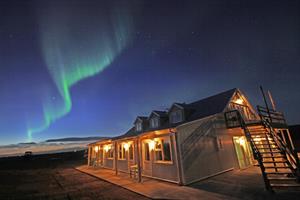 Northern lights dancing in the sky above Hotel Lækur