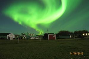 Northern lights dancing in the sky above Hotel Lækur