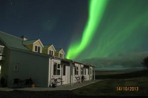 Northern lights dancing in the sky above Hotel Lækur