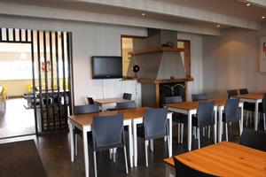 Hotel Sveinbjarnargerði Fireplace and dining room