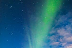 Man standing under Northern Lights