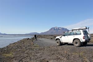 Driving along gravel road with a view towards Mt. Herðubreið